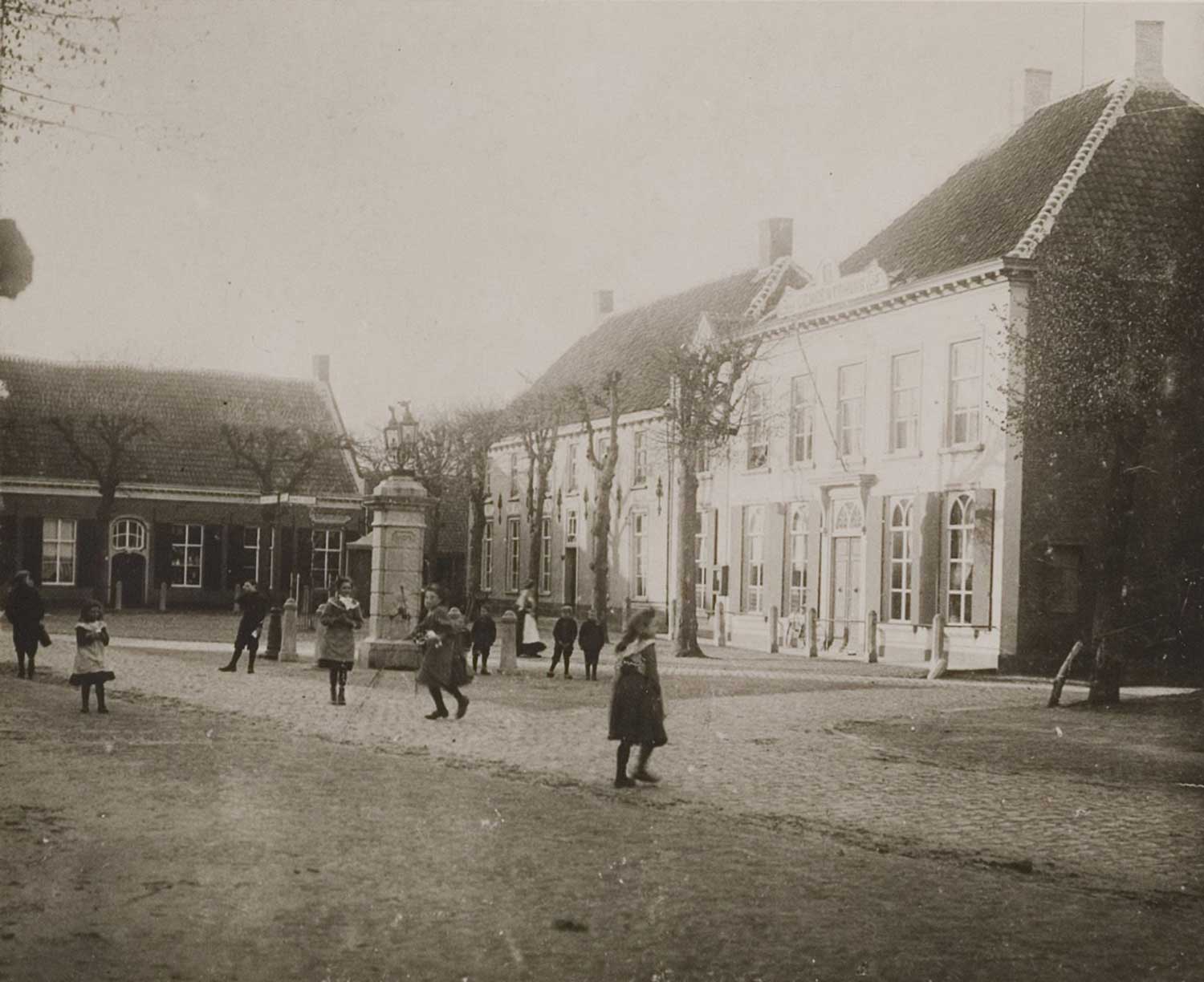 V.l.n.r. Smederij van L. van Puijenbroek, herberg van P. Olislaegers en het Raadhuis, 1907 (RAT)