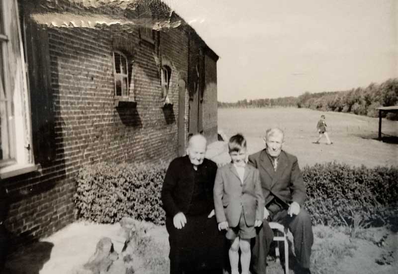 Wilhelmus van Roosmalen en Adriana van Zelst met een kleinkind bij de boerderij
